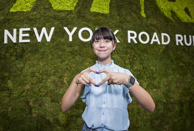 Youth Ambassador making a heart sign with her hands